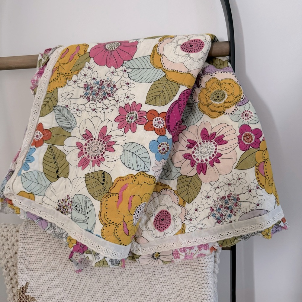 Cynthia Rowley quilted pillow sham with a multicolored boho floral pattern.
